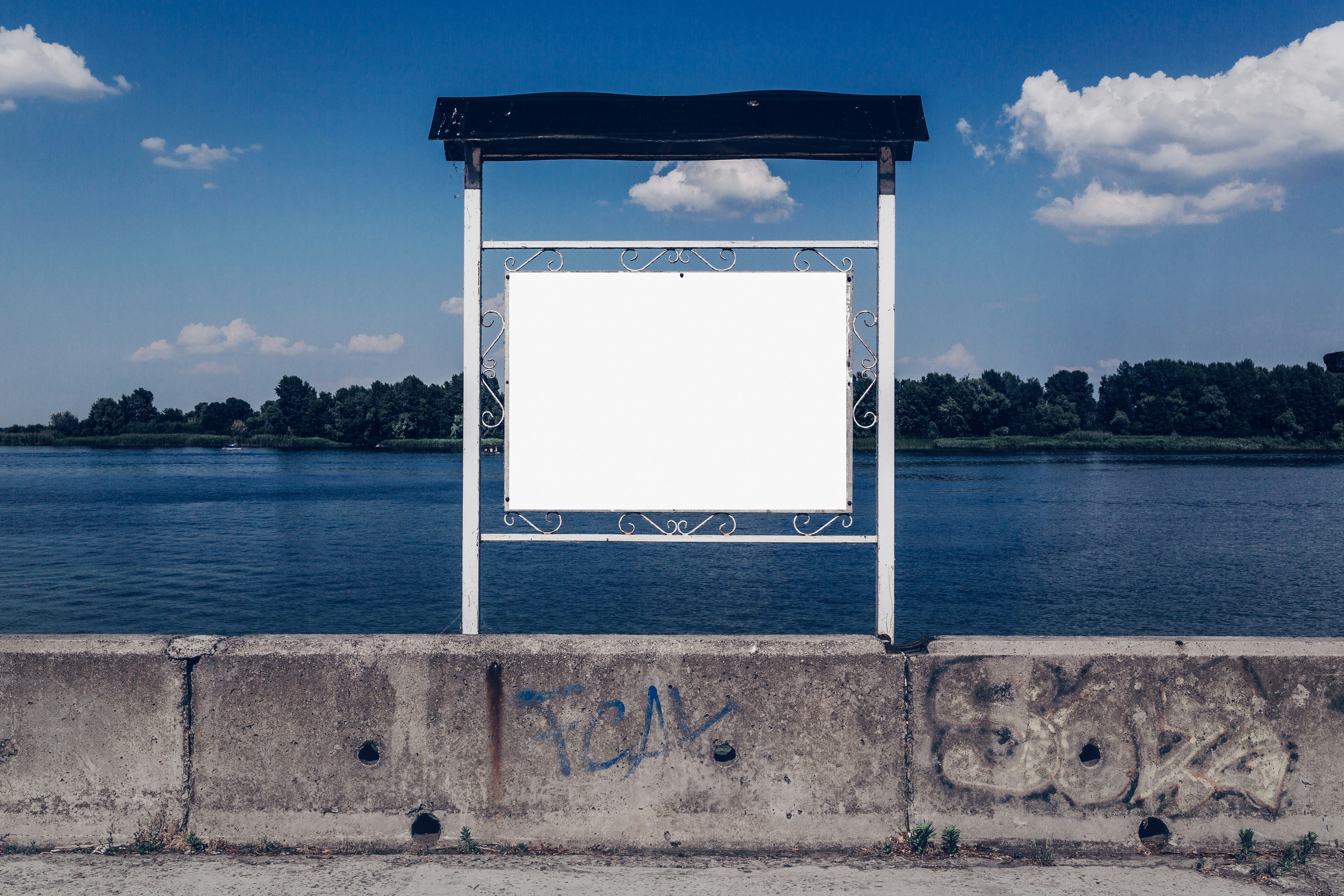 white and black metal frame near body of water